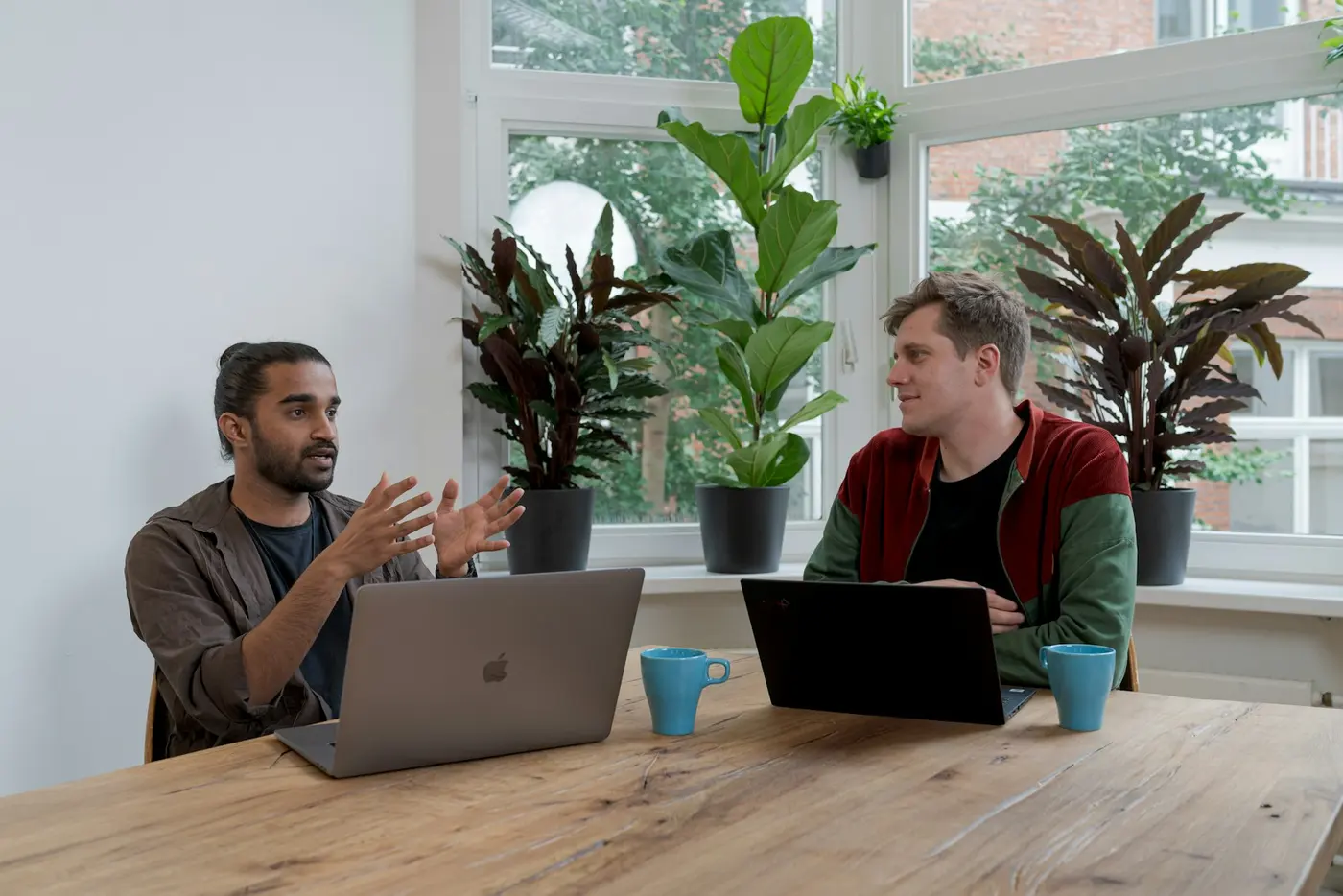 Two engineers discussing a project at a table