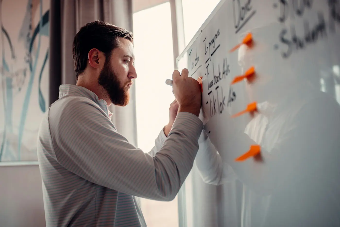 An engineer planning a feature on a whiteboard